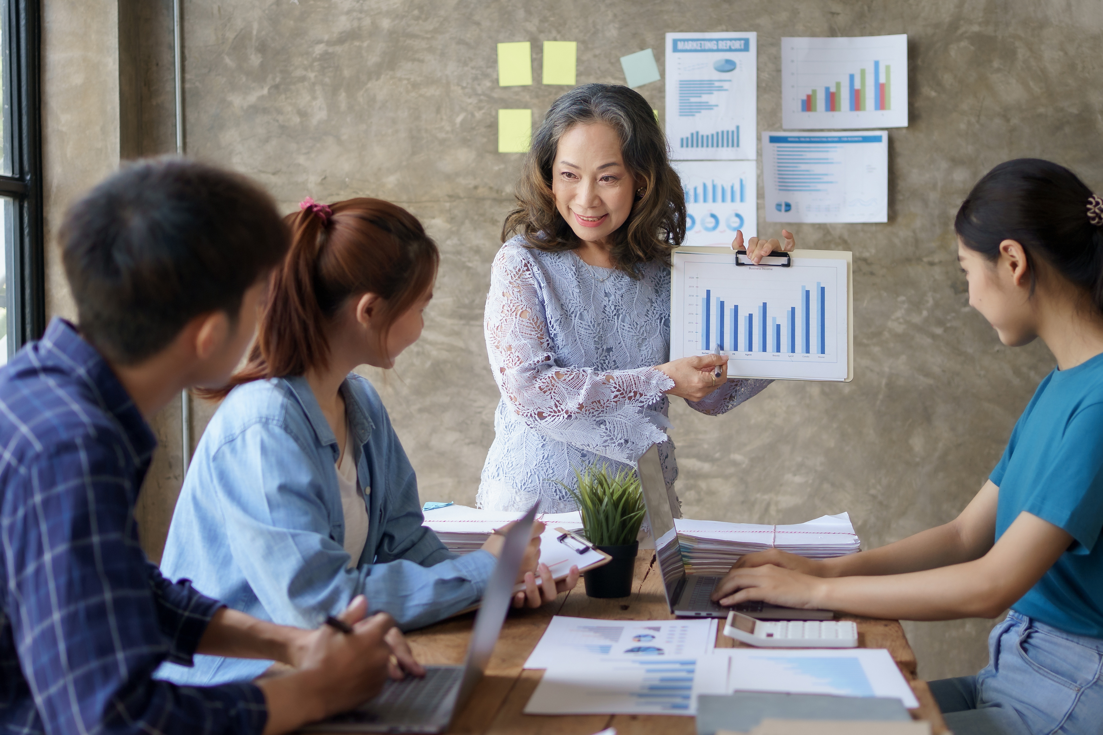 Business people collaborating and analyzing data in a conference room.